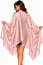 Load image into Gallery viewer, A woman wearing a shimmering light pink shawl wrap cape-style cover-up with wide draped sleeves, shown from the back against a plain white background.