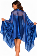Load image into Gallery viewer, A woman wearing a sheer royal blue high-low cape wrap, holding the wide sleeves out to show their drape against a plain white background.