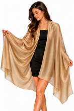 Load image into Gallery viewer, A woman modeling a flowing, semi-sheer metallic gold shawl or wrap over a black dress, set against a plain white background.