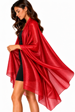 Load image into Gallery viewer, A woman modeling a flowing, open-front red shawl or wrap over a black dress against a plain white background.