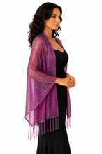 Load image into Gallery viewer, A woman wearing a sheer, shimmering purple open-front shawl with fringe tassels over a black dress, photographed against a plain white background.