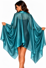 Load image into Gallery viewer, A woman shown from the back wearing a sheer, flowing teal-blue shawl and wrap pashmina cape-style cover-up over a dark dress, against a plain white background.