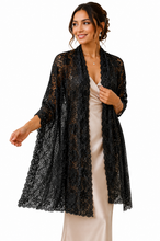 Load image into Gallery viewer, A woman models a black lace open-front cardigan over a light beige satin slip dress against a plain white background.