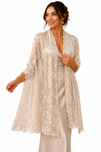 Load image into Gallery viewer, A woman modeling a long, open-front lace kimono-style cardigan in a warm ivory or champagne tone over a satin slip dress, against a plain white studio background.