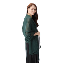 Load image into Gallery viewer, A woman modeling a dark green sheer shawl draped over her shoulders, paired with a black dress, against a solid white background.