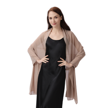 Load image into Gallery viewer, A woman modeling a lightweight beige shawl draped over a black satin slip dress against a plain white background.