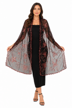 Load image into Gallery viewer, A woman modeling a sheer black mesh kimono-style wrap with wide sleeves, featuring dusty rose floral embroidery and scalloped edges, worn over a black midi dress against a plain white background.