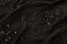 Load image into Gallery viewer, Black sheer tulle fabric with embroidered butterfly motifs and sequined floral patterns.