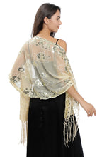 Load image into Gallery viewer, A woman shown from the back wearing a sheer beige shawl with metallic gold floral embroidery and fringe, over a black dress, against a plain white background.