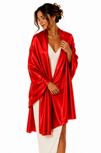Load image into Gallery viewer, A woman modeling a bright red satin pashmina  wrap over a white dress, photographed against a plain white studio background.