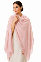 Load image into Gallery viewer, A woman modeling a light pink textured shawl draped over her shoulders, worn over a cream-colored dress against a solid white background.