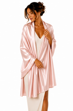 Load image into Gallery viewer, A woman modeling a light pink satin robe over a white ribbed knit top and white skirt, photographed against a solid white background.